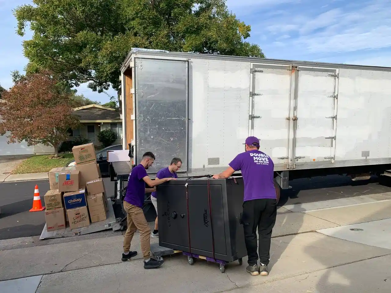 Double Move crew loading a heavy safe onto the truck